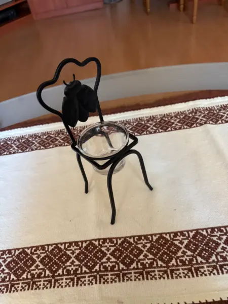 Dekorativní kovový svícen ve tvaru židle s broukem